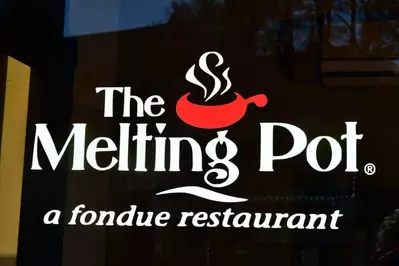 The sign for the Melting Pot restaurant welcomes guests to a delicious fondue dinner.