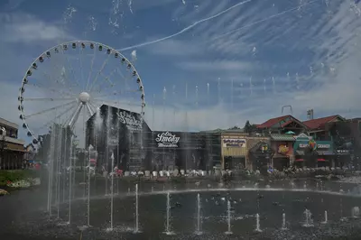 the island show fountain with shops in the background at the island in pigeon forge